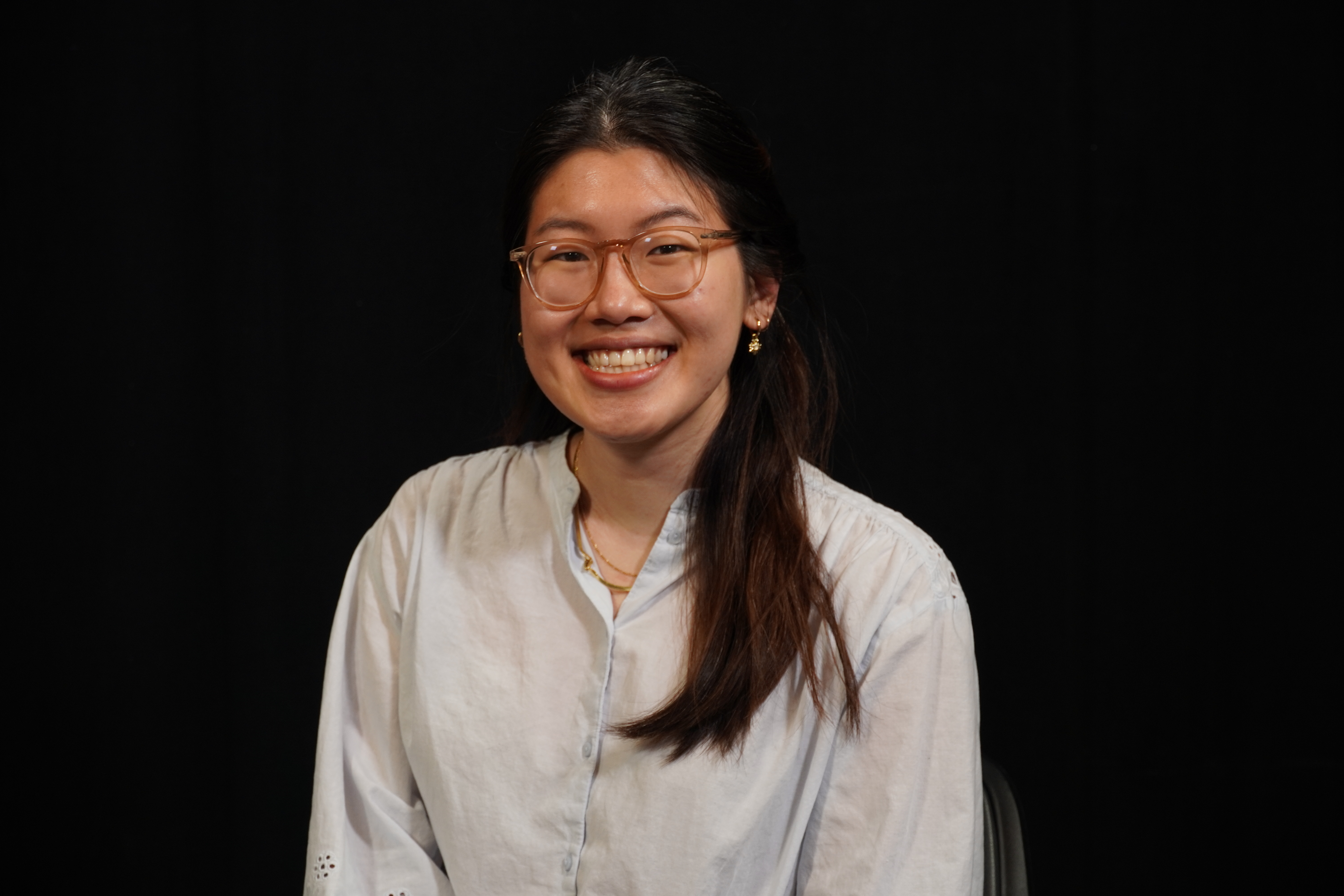 Headshot of Gloria Shin against black background