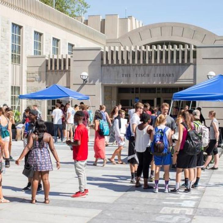 Tisch Library patio with students at open house.
