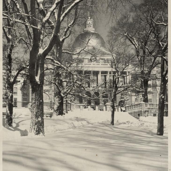Black and white photograph of Boston Common and State House in snow