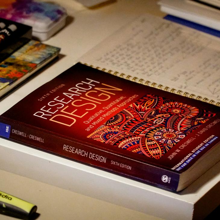 Research Design textbook on desktop