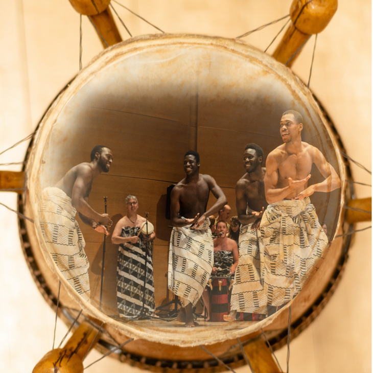 Five people performing an African dance