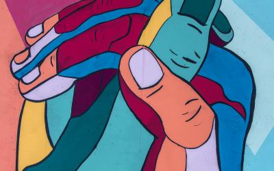 DEIJactionplan Two colourful mosaic hands holding eachother
