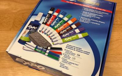 Original box from dry erase marker set showing the contents - 12 markers, an eraser and a bottle of cleaner