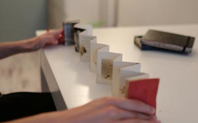 A handmade accordion fold zine stretched out on a table