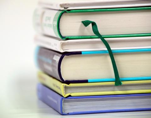 Stack of 6 books, showing spines & bottom of books