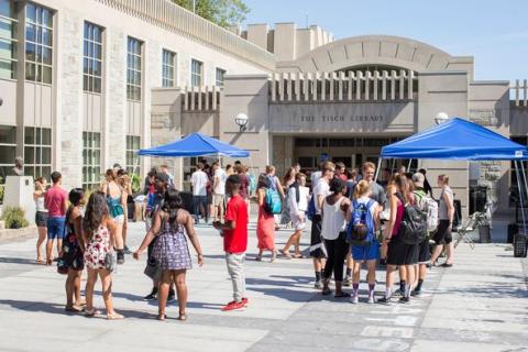 Tisch Library patio with students at open house.