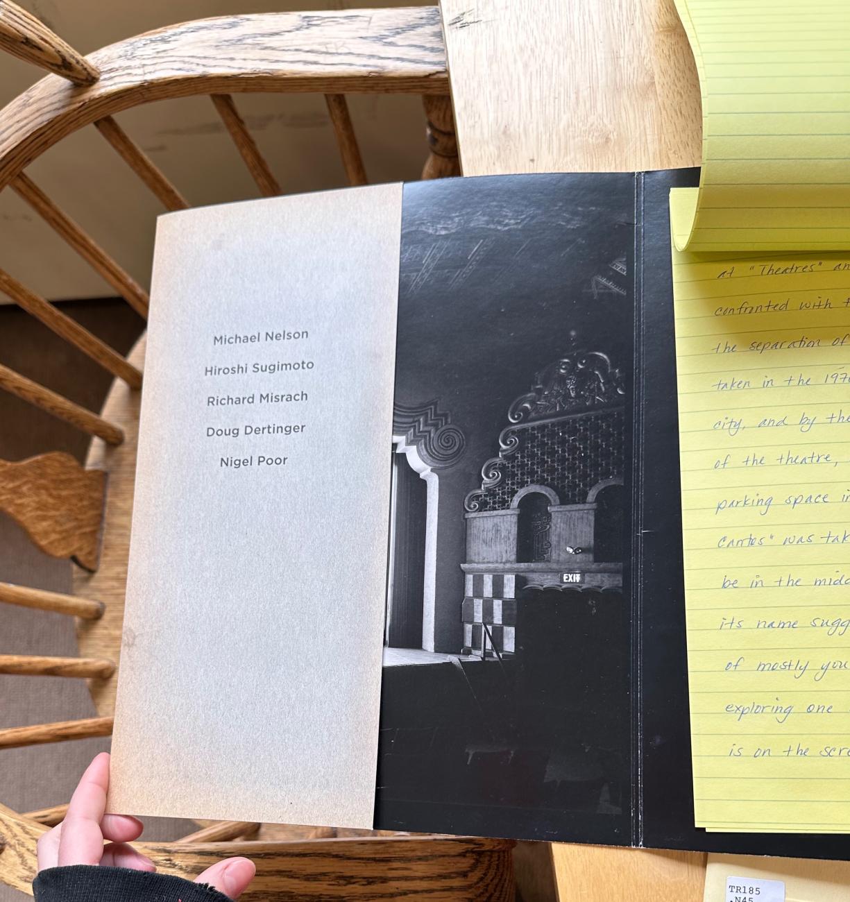 An open book showing a photograph and yellow legal pad