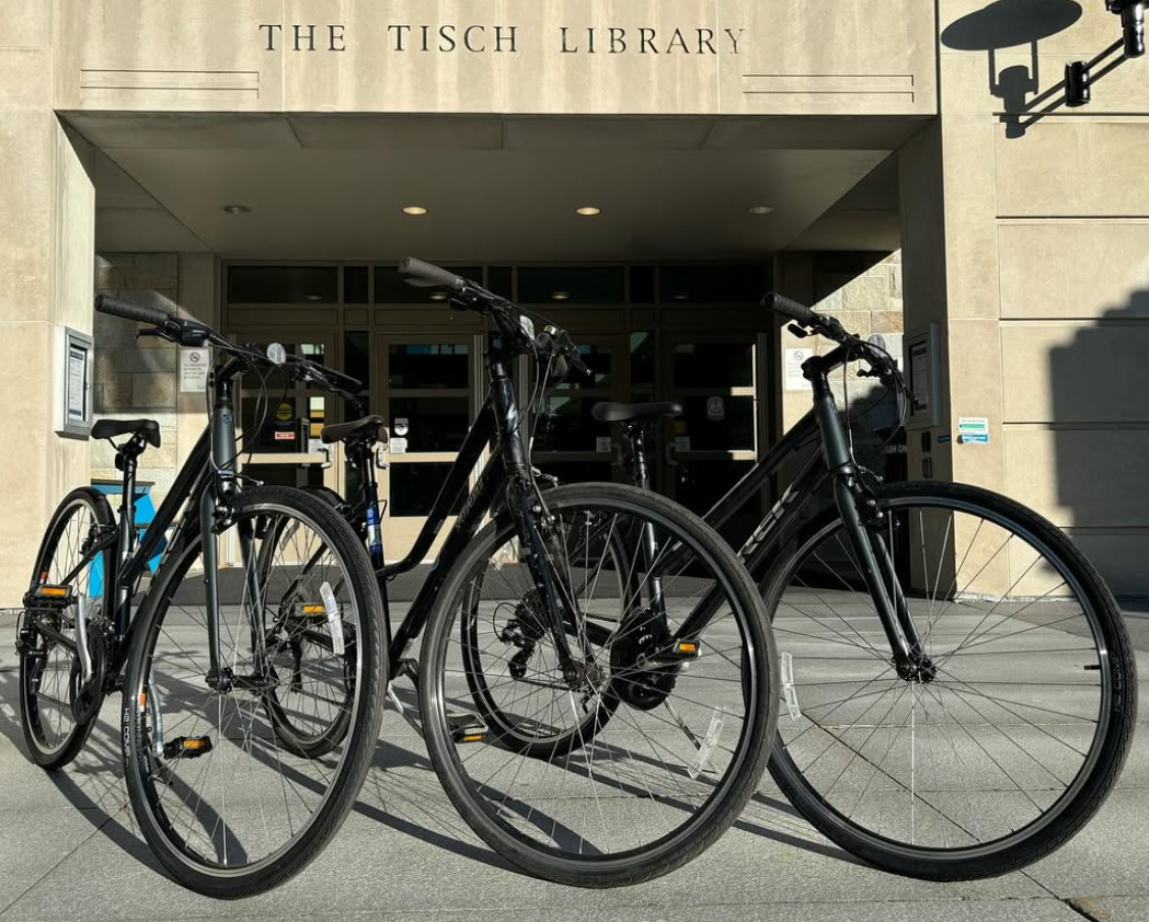 Three Tufts Bikes Share program bikes in front of the Tisch Library Entrance