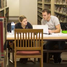 students collaborate in library