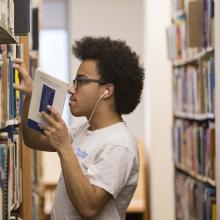 student browses books in the library