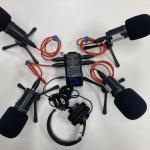 Four microphones plugged into audio recording device